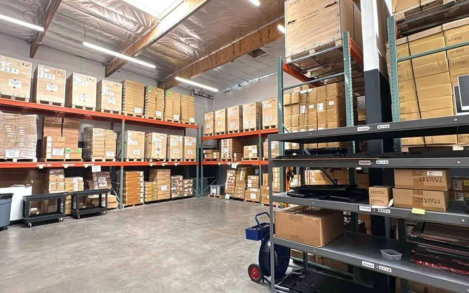 The open floor between the racking, with staging carts and boxed stock