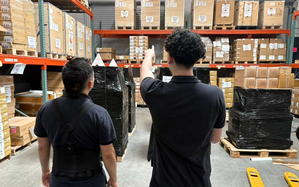 Two of our team checking a pallet location on the racking above them