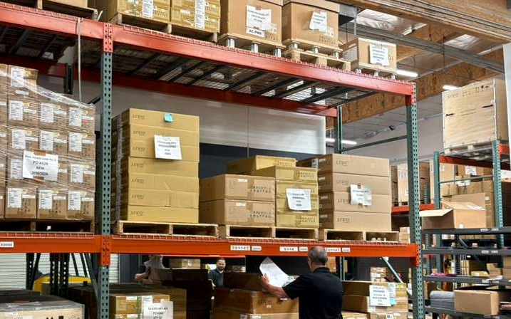 A team member checking inbound Juniper stock against the paperwork
