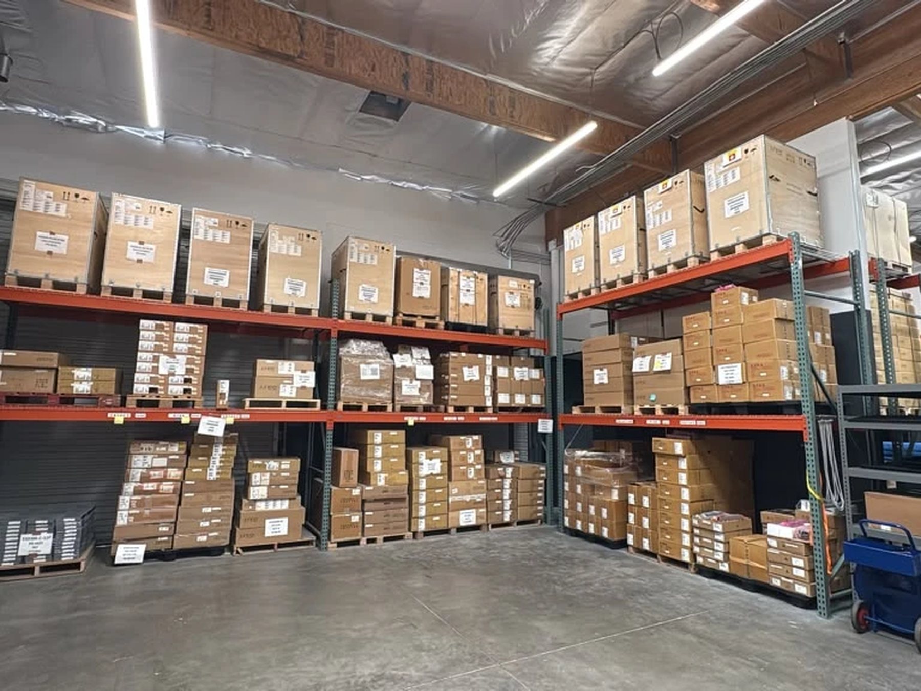 Pallet racking stocked with boxed enterprise hardware on our warehouse floor