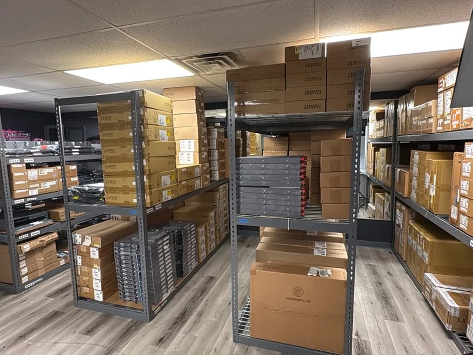 Bin-located parts shelving holding switches, line cards, optics, and accessories